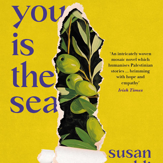 This image features the cover of the book "Behind You Is the Sea" by Susan Muaddi Darraj. The cover has a yellow background, that is tearing away to reveal an illustration of green olives on the vine.
