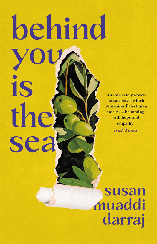 This image features the cover of the book "Behind You Is the Sea" by Susan Muaddi Darraj. The cover has a yellow background, that is tearing away to reveal an illustration of green olives on the vine.