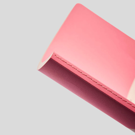 Close-up of a pink notebook on a light gray background
