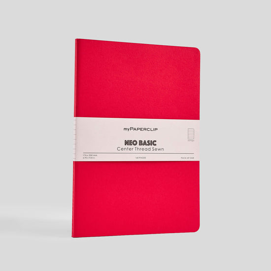 Red notebook with a white label on a gray background
