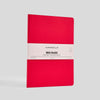Red notebook with a white label on a gray background