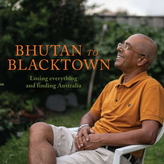 The cover of the book 'Bhutan to Blacktown' features a man in an orange shirt smiling and sitting in a chair outdoors. 