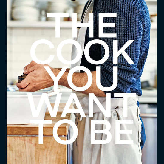 A cookbook cover featuring a man in a kitchen setting, with the title 'The Cook You Want to Be' by Andy Baraghani.