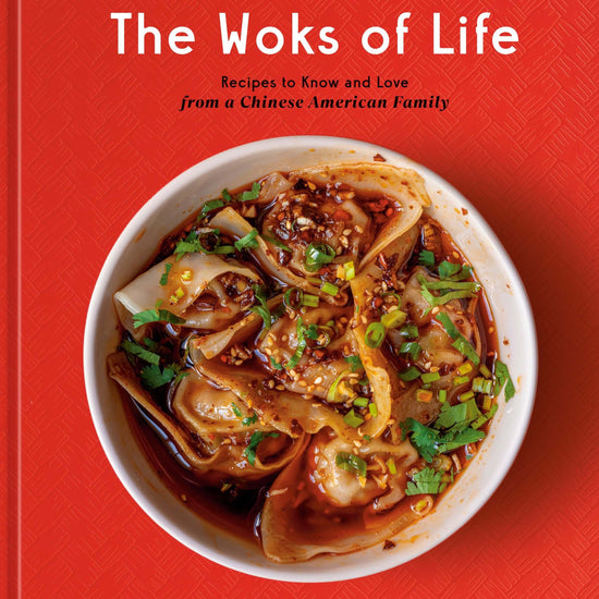 The cover of the book 'The Woks of Life' featuring a bowl of dumplings, on a red background with a floral pattern at the top.