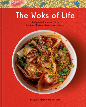 The cover of the book 'The Woks of Life' featuring a bowl of dumplings, on a red background with a floral pattern at the top.