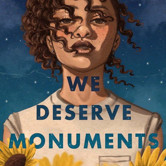 Cover of the book 'We Deserve Monuments' featuring a young woman with curly hair, set against a celestial blue background with yellow flowers